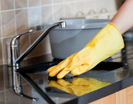 Window cleaner servicing a Putney home with clear residential windows